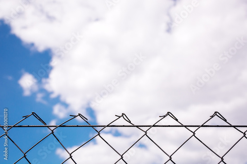 From a metal grid to the blue sky with white clouds