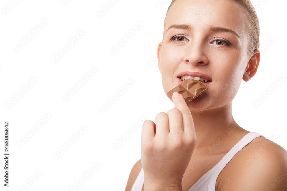 Blonde young woman biting chocolate isolated Blonde young woman biting chocolate isolated