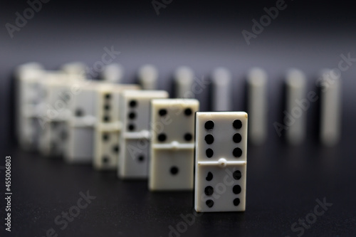 Domino tiles in line on black background