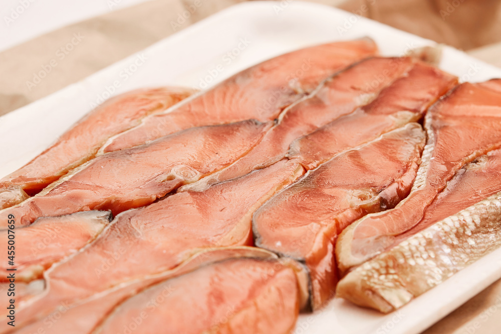 Red fish fillet meat close-up. Smoked trout or salmon, texture and macro photo. Content for an online store or advertising. Seafood close up