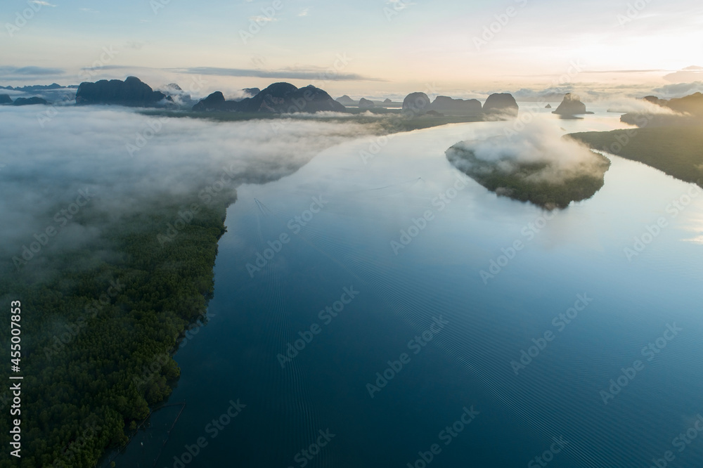 Obraz premium Aerial view drone shot of beautiful ocean against sky in the morning fog mist sunrise drone is flying over sea and mangrove forest Landscape High angle view Dynamic aerial shot Amazing nature view.
