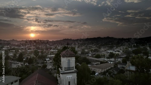 Wallpaper Mural Aerial shot of Spanish architecture church at sunset in the city. Cross silhouette on top of church steeple. Los Angeles, CA Torontodigital.ca