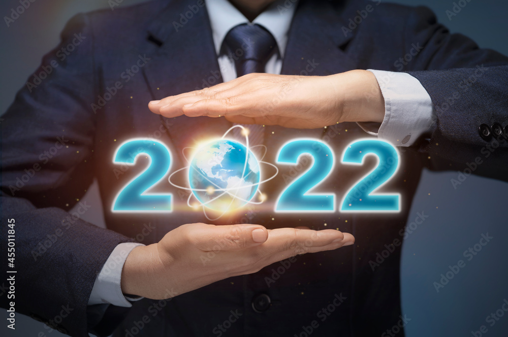 Business man start up business in 2022. Businessman hold world map and 2022 show happy new year 2022, Business Goal, Future plan, New year plan, Aim to business success, World economic growth concept. Business man start up business in 2022. Businessman hold world map and 2022 show happy new year 2022, Business Goal, Future plan, New year plan, Aim to business success, World economic growth concept.