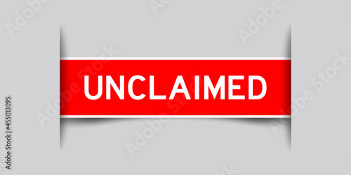 Label sticker red color in word unclaimed that inserted in gray background