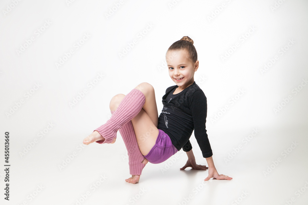 Portrait of a pretty little girl doing gymnastics over white background Portrait of a pretty little girl doing gymnastics over white background