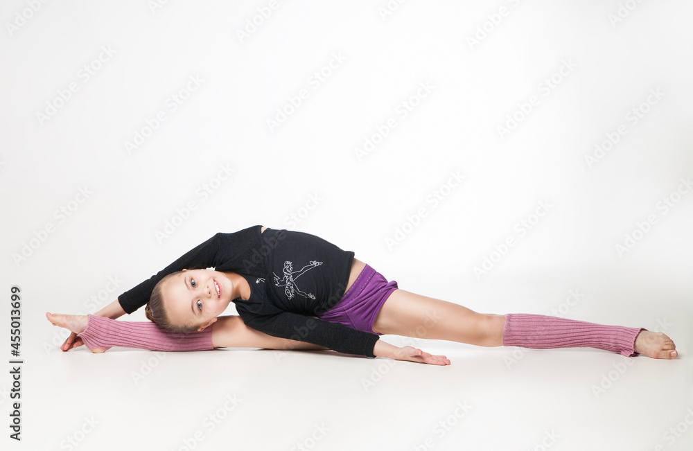 Portrait of a pretty little girl doing gymnastics over white background Portrait of a pretty little girl doing gymnastics over white background