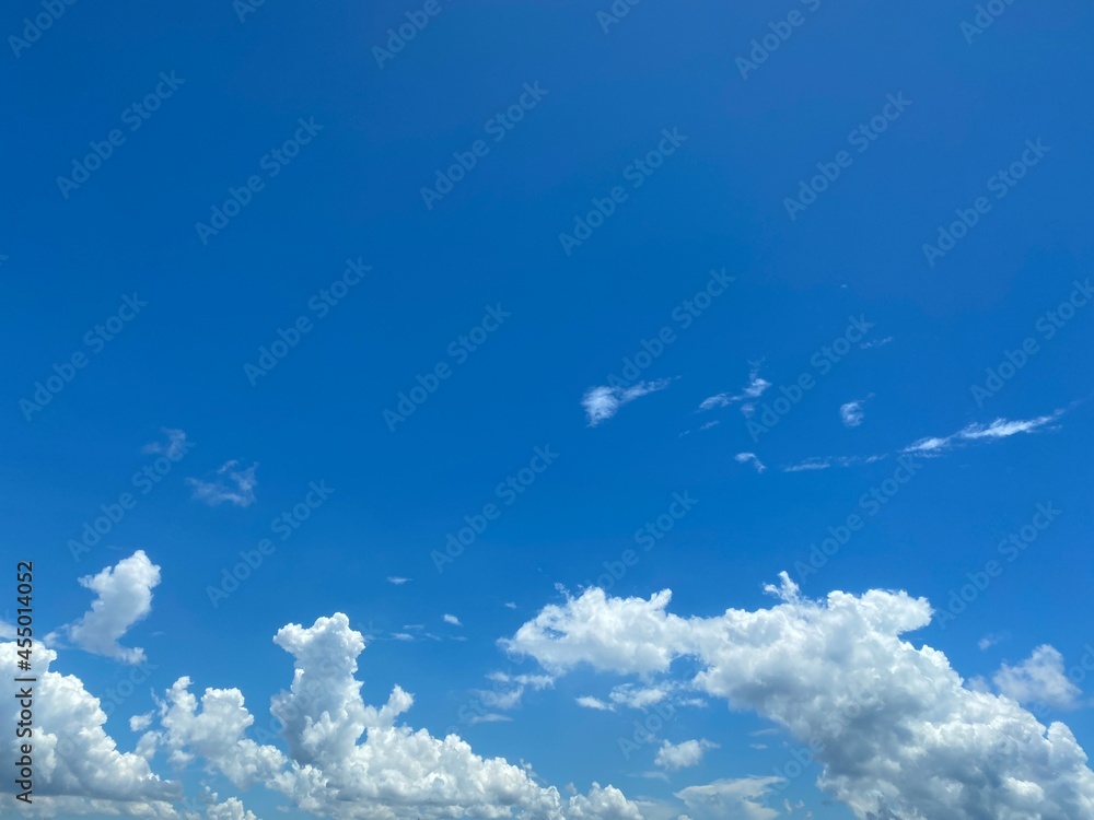 Distant white clouds on a blue sky. Distant white clouds on a blue sky.