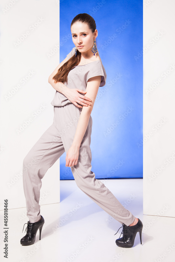 Photo of beautiful girl is in fashion style over blue background Photo of beautiful girl is in fashion style over blue background