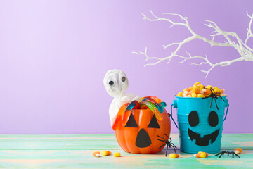 Halloween celebration concept with candy corn and candy in jack o lantern bucket for trick and treat