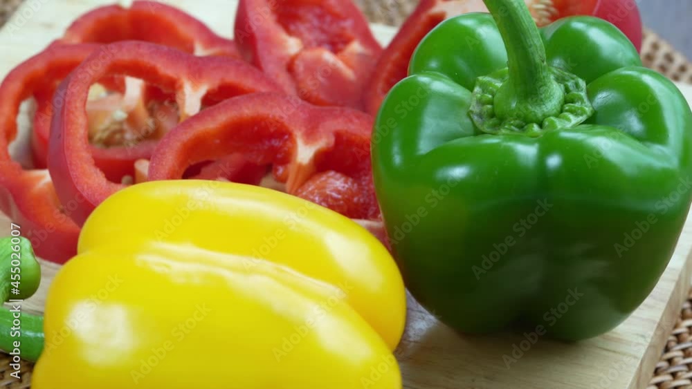 Sweet Bell pepper on Wooden background, Top view Rotate Sweet red green yellow pepper on Wooden background, 4k resolution. Sweet Bell pepper on Wooden background, Top view Rotate Sweet red green yellow pepper on Wooden background, 4k resolution.