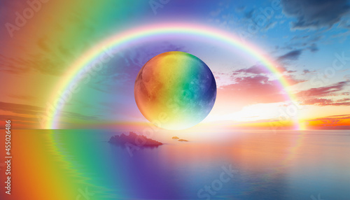 Full glass moon  or crystal ball moon  rising over empty sea with double sided rainbow at amazing sunset