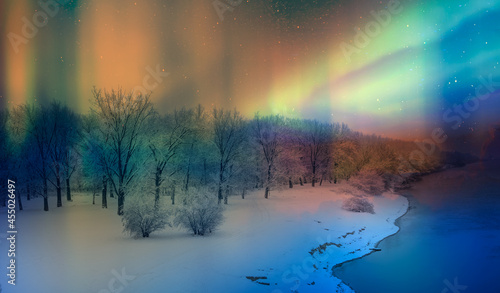 Northern lights or Aurora borealis in the sky in the forest on the river