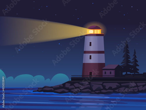 A lighthouse at night on the coast of the sea or ocean illuminates the path with a searchlight beam