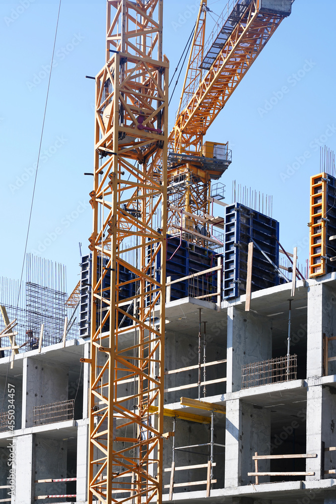 Construction crane on the background of the sky. Close-up of a reinforced concrete building. Construction concept. High quality photo