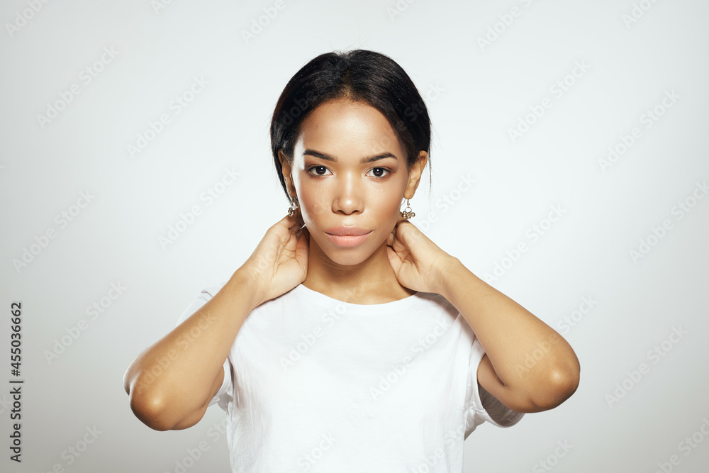 pretty woman in white t-shirt long hair earrings jewelry studio pretty woman in white t-shirt long hair earrings jewelry studio