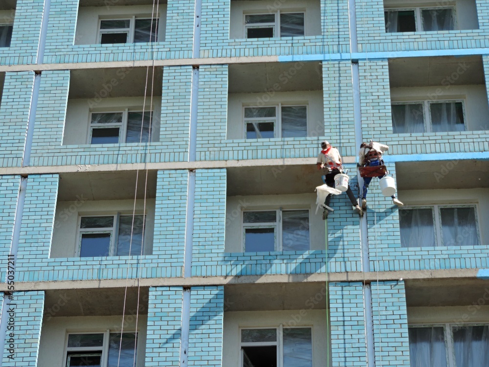 Fototapeta premium Construction works at a height. Construction of a multi-storey building. 