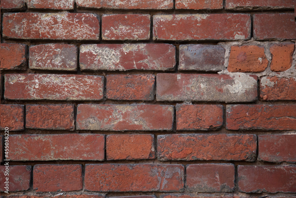 the texture of a red old brick wall with white scuffs. the texture of a red old brick wall with white scuffs.