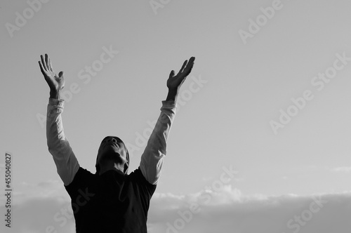 man praying with sky background stock photo