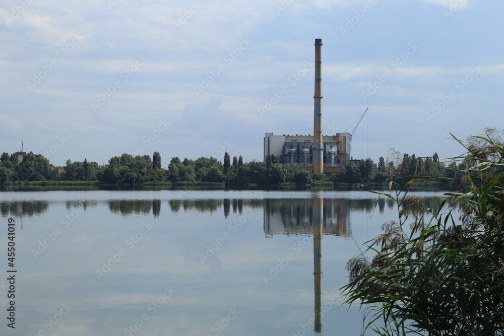 Factory with a chimney by the lake
