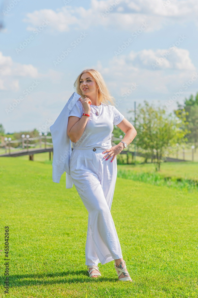 Nice blonde hair woman in cotton suit at golf field. Concept of women's style, fashionable collection Nice blonde hair woman in cotton suit at golf field. Concept of women's style, fashionable collection