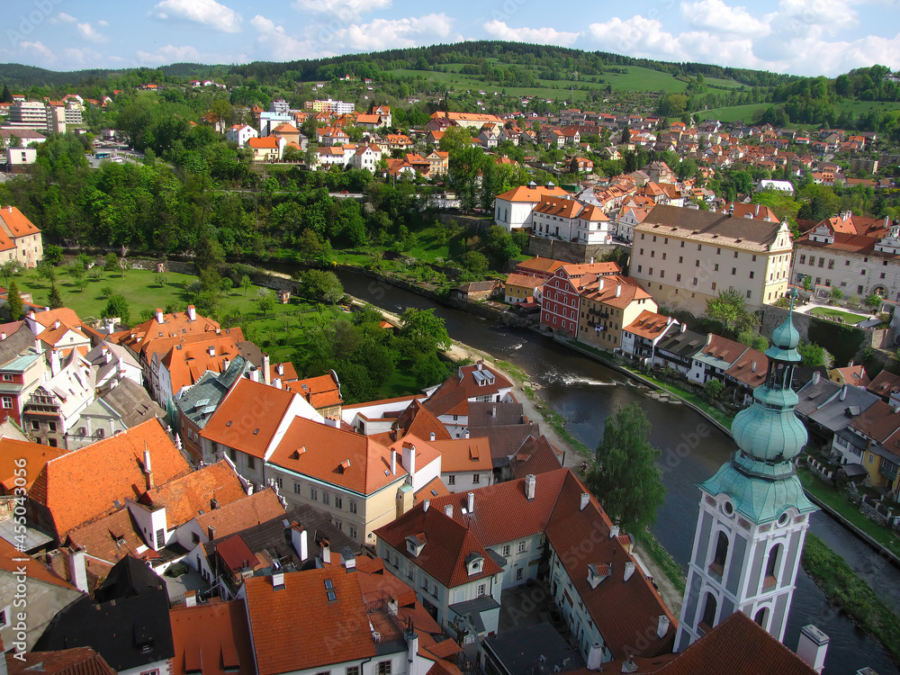 Townscape of beautiful Cesky Krumlov in orange color roofs and green in sunny day