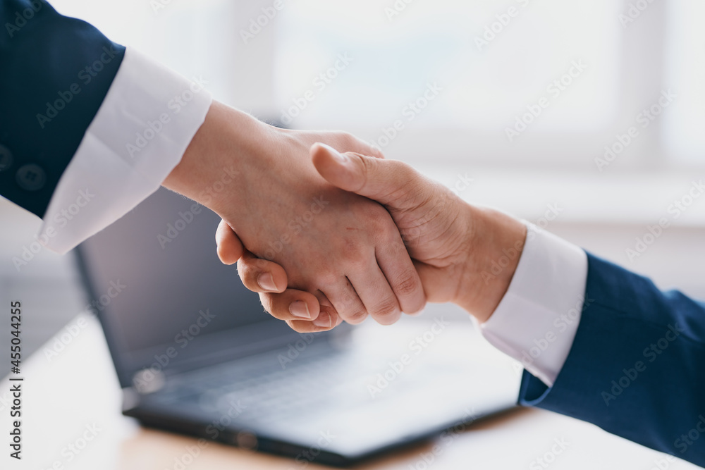 managers shaking hands successful deal office laptop professionals managers shaking hands successful deal office laptop professionals