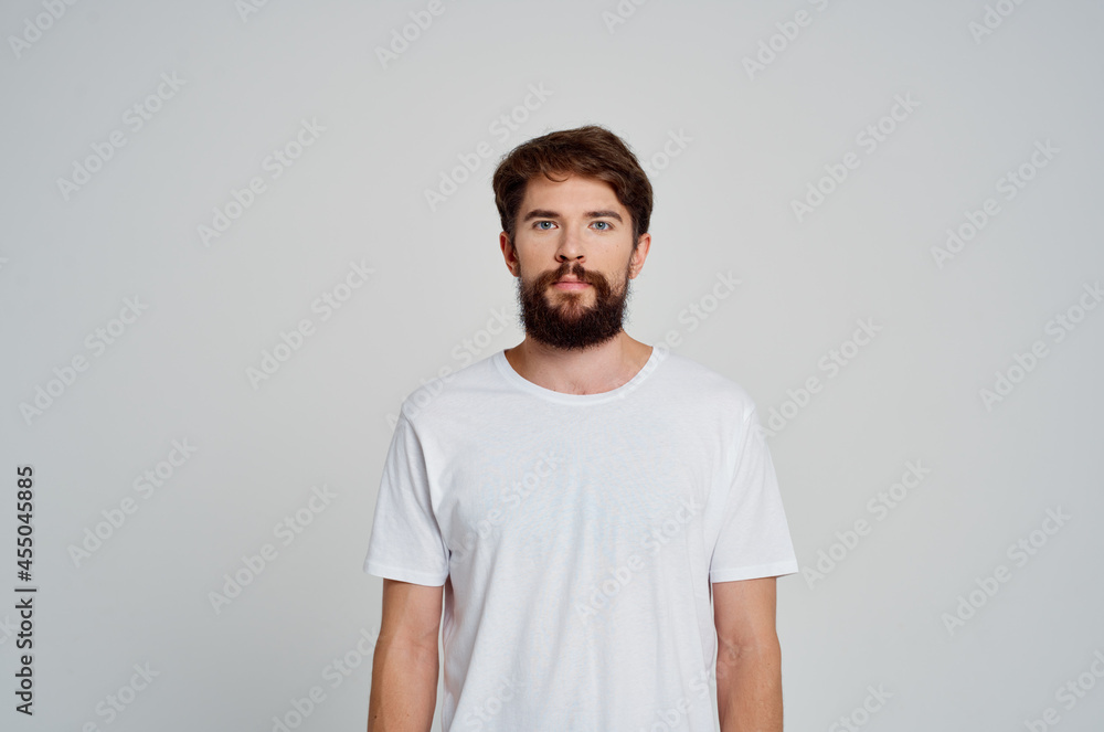 portrait of a bearded man white t-shirt studio cropped view portrait of a bearded man white t-shirt studio cropped view