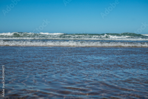 waves on the barrosa beach, at low tide, in sancti petri, cadiz