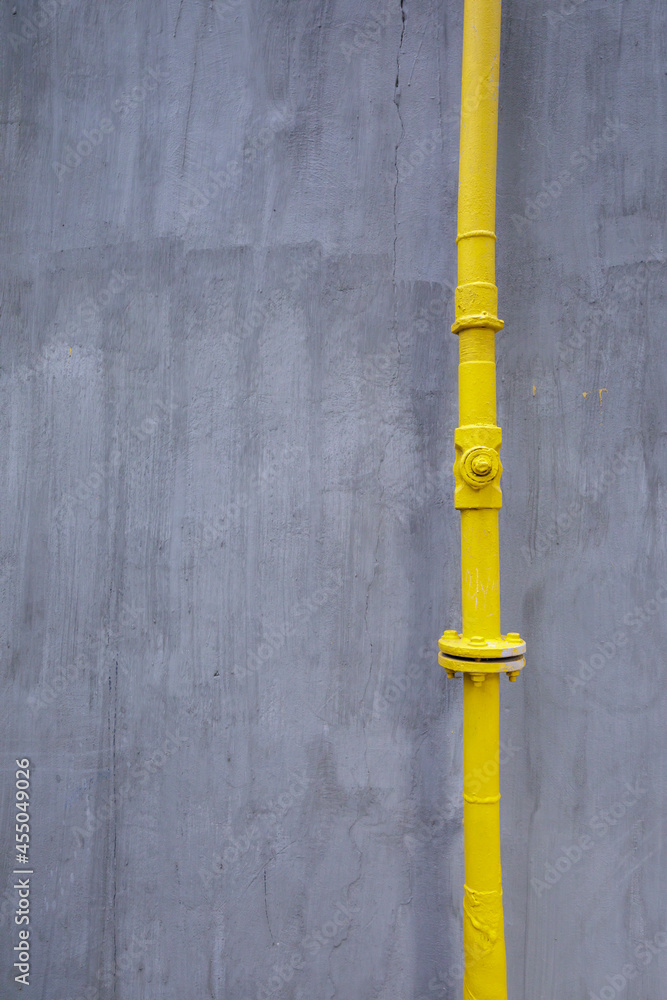 A minimalistic composition of a metal pipeline and a wall. A minimalistic composition of a metal pipeline and a wall.