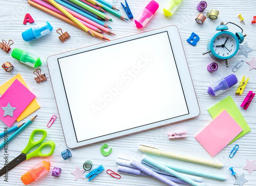 Frame of different stationery on white wooden background