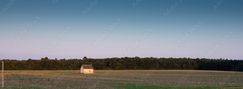 old shed in empty cornfield at sunset in Parc naturel régional Loire-Anjou-Touraine