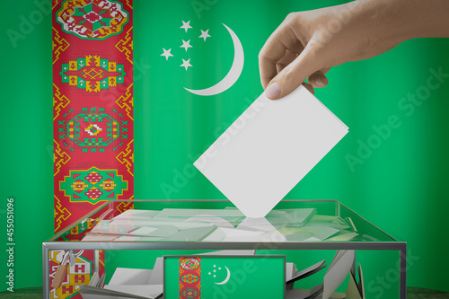 Turkmenistan flag, hand dropping ballot card into a box - voting, election concept - 3D illustration