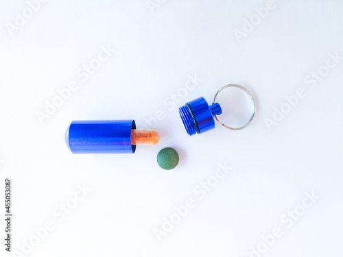 blue pill box with pills on white background