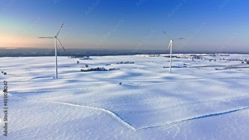 Alternative energy in winter, Poland. Wind turbine on snowy field. Alternative energy in winter, Poland. Wind turbine on snowy field.
