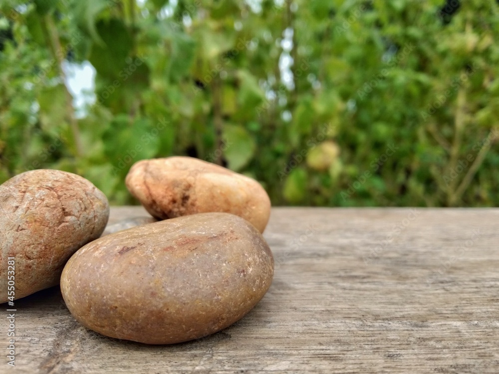 zen stones with brown planks blur background zen stones with brown planks blur background