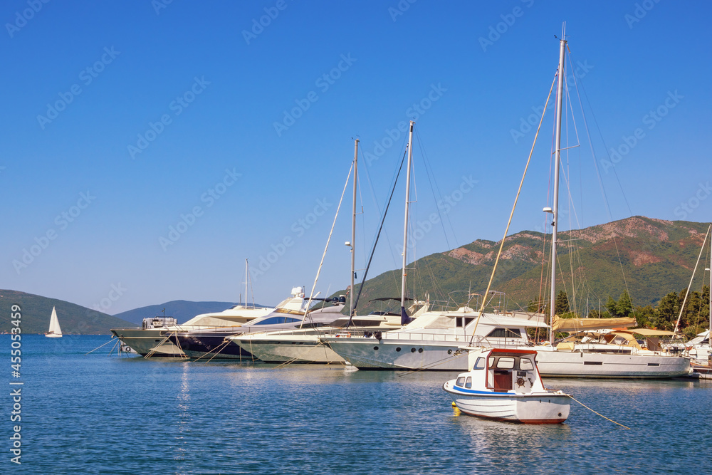 Beautiful  Mediterranean landscape. Sailboats and fishing boats on water. Montenegro, Adriatic Sea. View of Kotor Bay near Tivat city