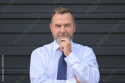 Astute thoughtful businessman staring at the camera