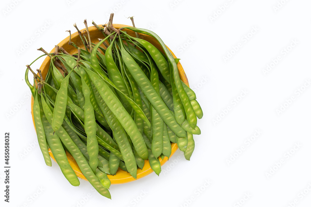 Naklejka premium Young fruit of Leucaena leucocepphala in yellow plate on white background.