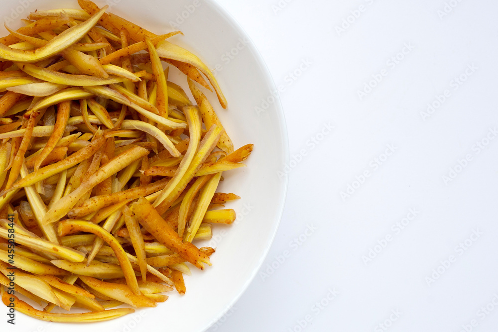 Sliced finger root in white plate on white background. Sliced finger root in white plate on white background.