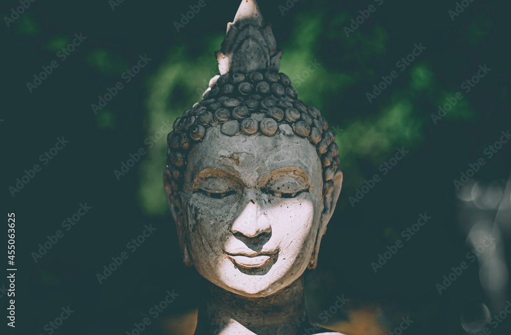 Statue of Buddha standing in meditation.Close up hand of statue Buddha.buddhism concept .peacefulness idea .lifestyle practise mind in clamness
