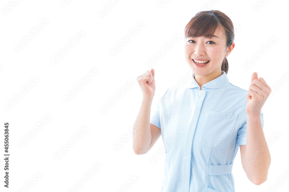 ガッツポーズをする若い看護師 ガッツポーズをする若い看護師
