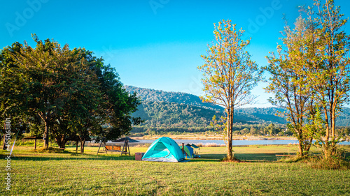 Pyramid Tent Camping Tent in Blue among forest nature with mountain against blue sky in background at Khaoyai Thailand