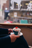 girl holding coffee with cherry on top