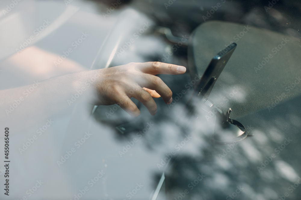 Navigator in car vehicle transportation commuter. Driver man pointing hand finger mobile phone navigator app while driving car.