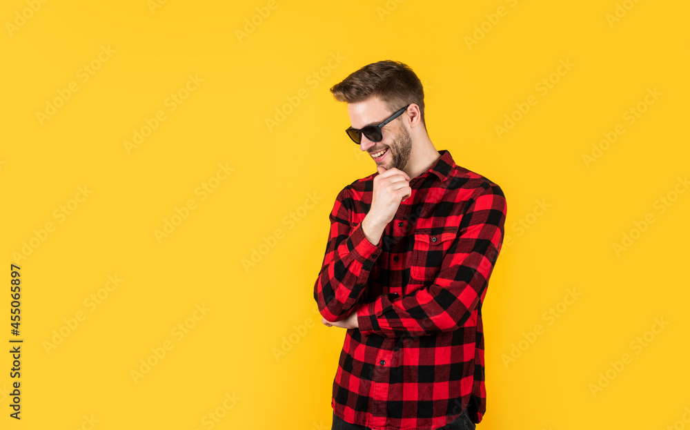 handsome confident young man standing in shirt and glasses. happy guy smiling. portrait of fashionable handsome man in shirt. business classic mens shirts with checkered print. copy space handsome confident young man standing in shirt and glasses. happy guy smiling. portrait of fashionable handsome man in shirt. business classic mens shirts with checkered print. copy space