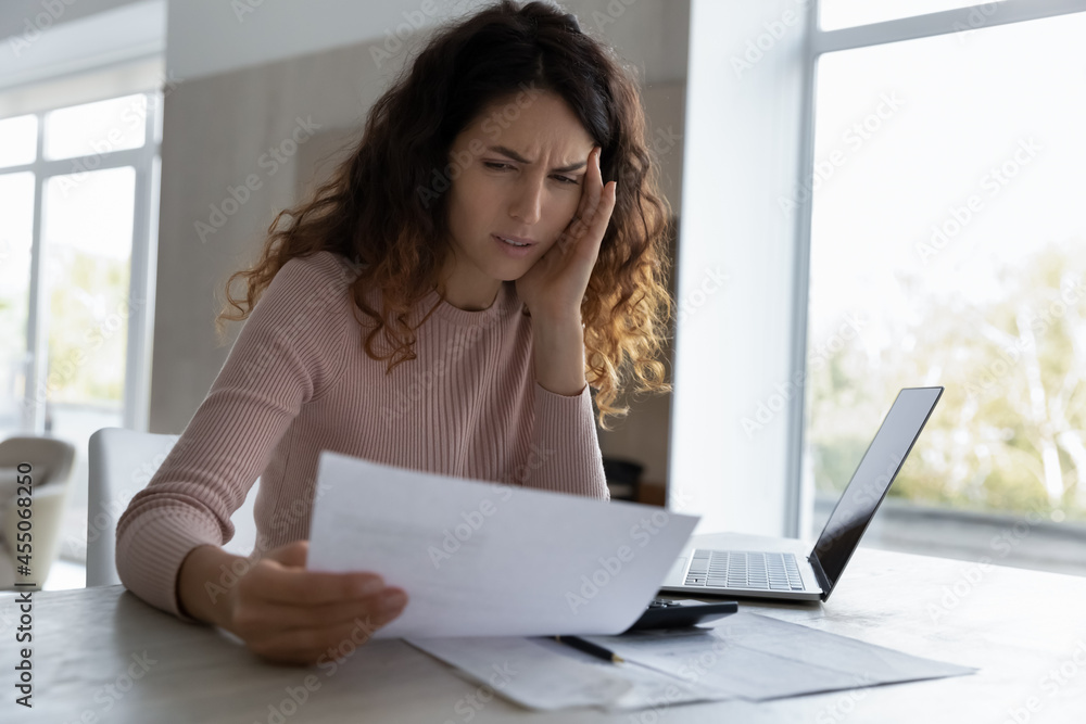 Nervous unhappy young hispanic woman looking through paper document, feeling stressed of getting bank loan rejection notification or job dismissal notice, having financial problems, bankruptcy concept Nervous unhappy young hispanic woman looking through paper document, feeling stressed of getting bank loan rejection notification or job dismissal notice, having financial problems, bankruptcy concept