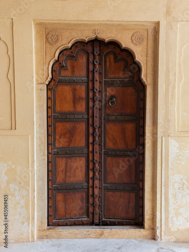 Traditional ornamental wooden door in Amber Fort, Mughal palace in Jaipur, India.