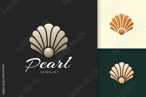 Abstract pearl or jewelry logo in luxury and shell shape fit for beauty and cosmetic