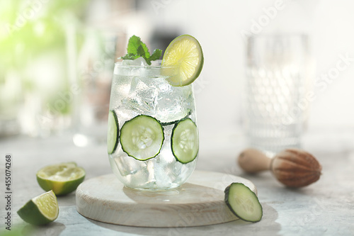 Cucumber cocktail lemonade with lime on the table photo