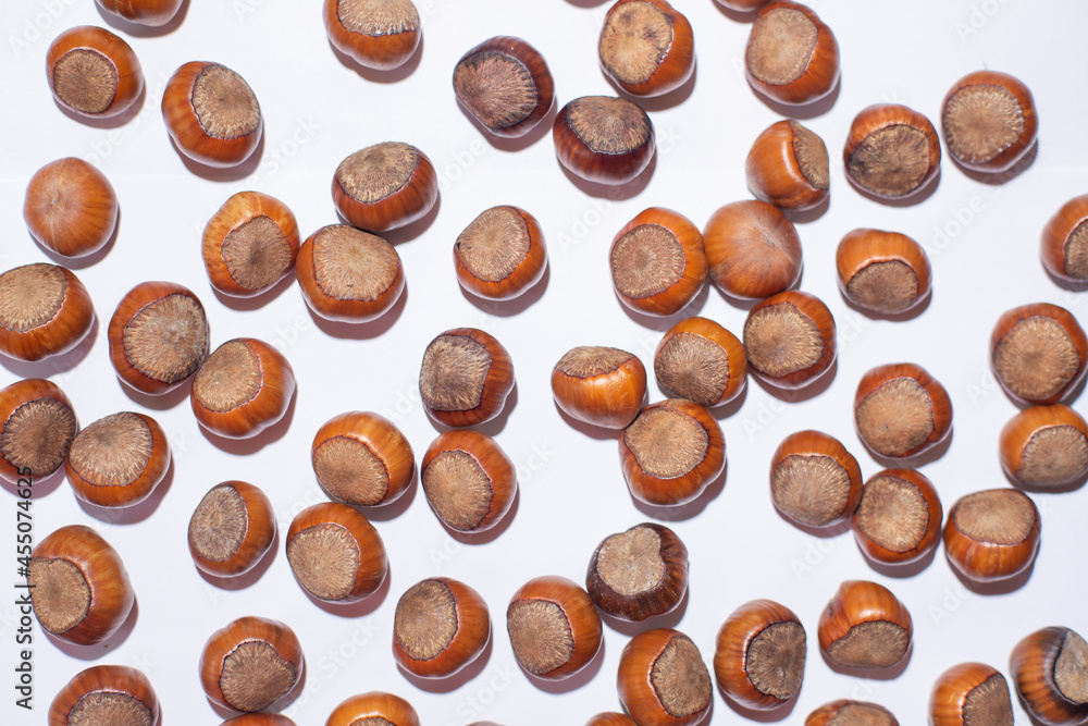 Nuts in shell, hazelnuts on a white background. heap or pile of nuts. Nuts background, healthy food Nuts in shell, hazelnuts on a white background. heap or pile of nuts. Nuts background, healthy food